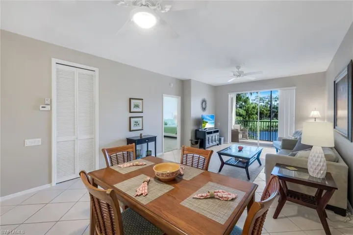 Dining space with light tile patterned floors and ceiling fan