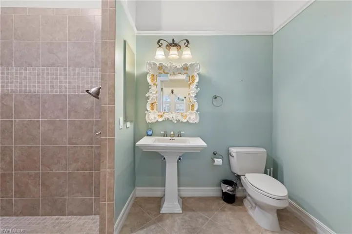 Bathroom with tile patterned flooring and a shower stall