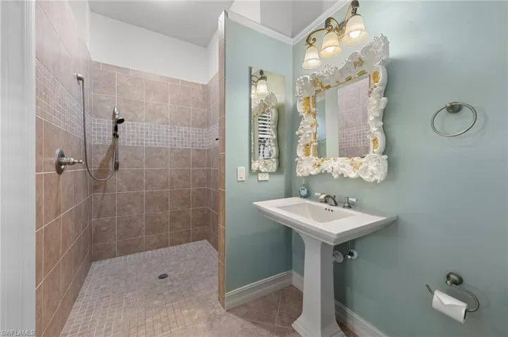 Full bath featuring a tile shower and light tile patterned floors