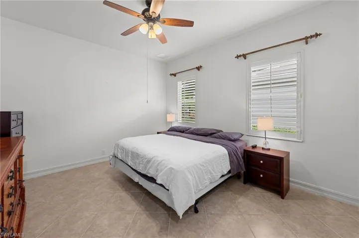 Bedroom featuring a ceiling fan and light tile patterned floors