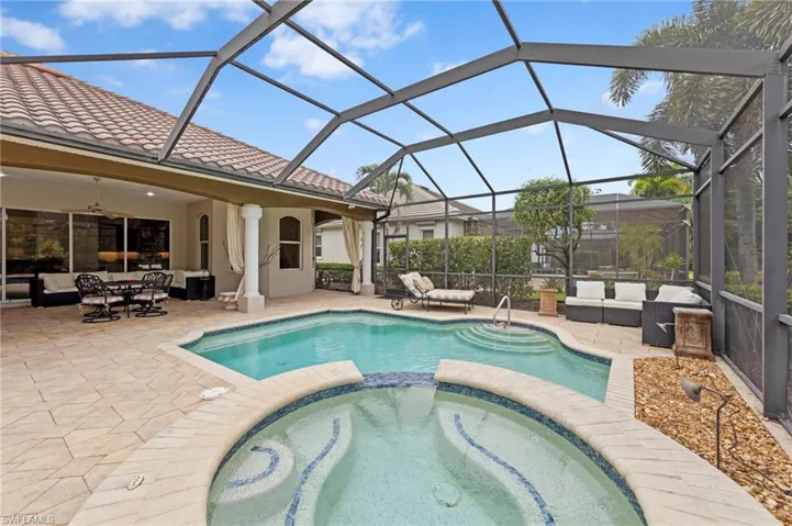 View of pool with an outdoor living space, a sunroom, a pool with connected hot tub, and a patio area