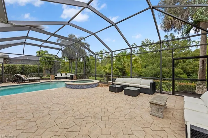 View of pool with an outdoor hangout area, a lanai, a sunroom, and a pool with connected hot tub
