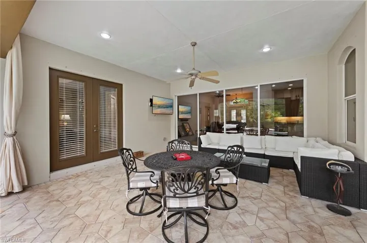 View of patio with french doors, an outdoor living space, a ceiling fan, and outdoor dining space
