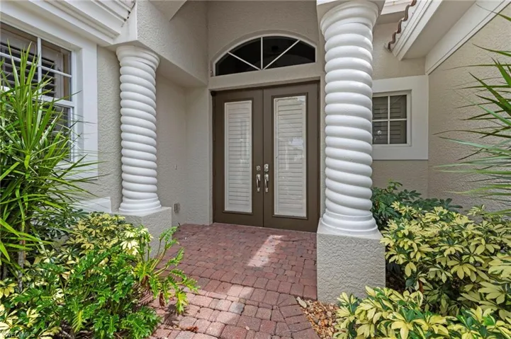 Property entrance with french doors and stucco siding