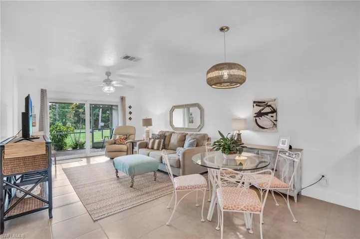 Tiled dining room featuring ceiling fan