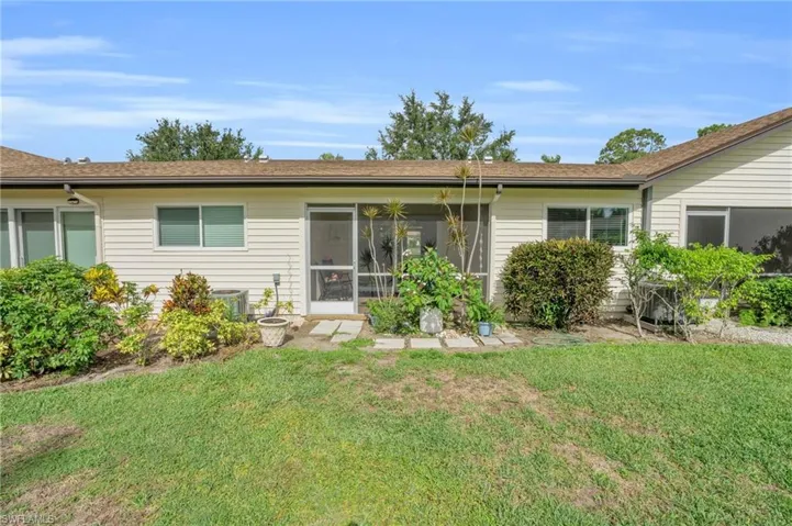 Rear view of house with a lawn