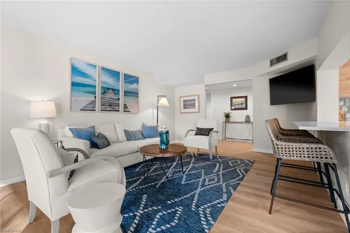 Living area featuring light wood-type flooring and baseboards