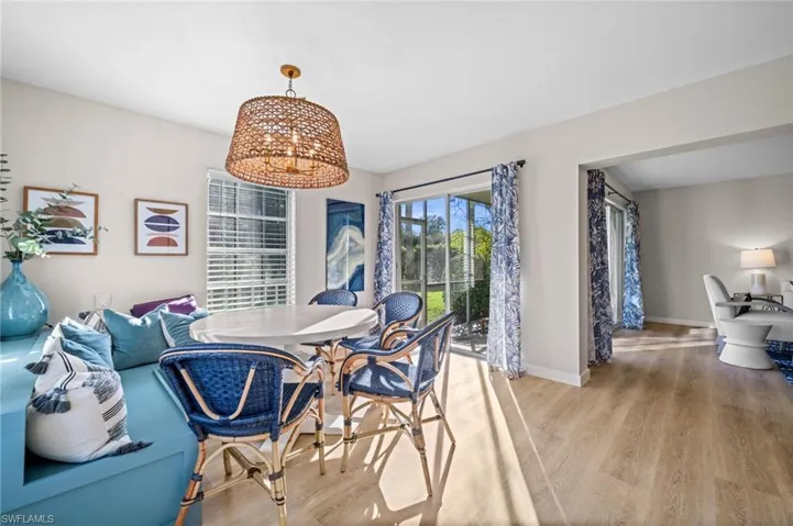 Dining space with wood finished floors and a chandelier