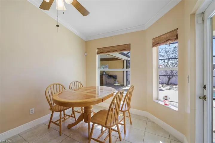 Dining room featuring ornamental molding, ceiling fan, and tile patterned flooring