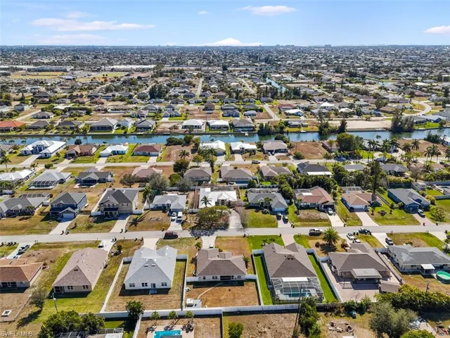 Aerial view of property's location featuring nearby suburban area and a large body of water