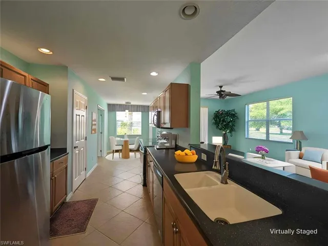 Kitchen with ceiling fan, stainless steel appliances, a healthy amount of sunlight, and sink
