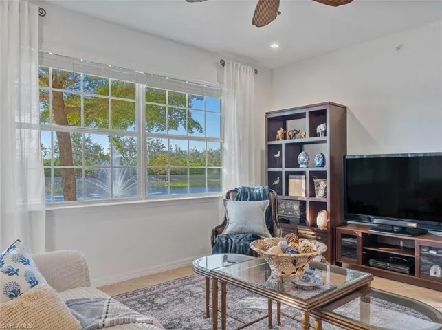 Living area featuring a ceiling fan, light tile patterned floors, and recessed lighting