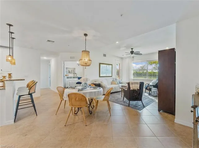 Dining space with a ceiling fan, light tile patterned floors, and recessed lighting