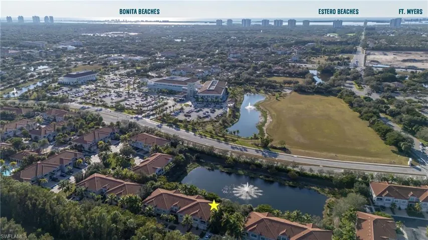 Aerial view of property's location featuring a large body of water and nearby urban area