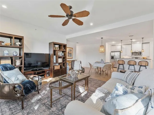 Living room featuring ceiling fan, recessed lighting, and light tile patterned floors