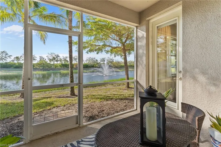 Sunroom / solarium featuring a water view