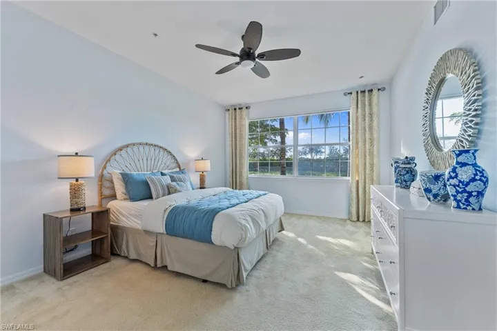 Bedroom featuring light carpet and ceiling fan