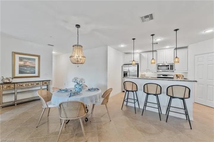 Dining space with recessed lighting and baseboards