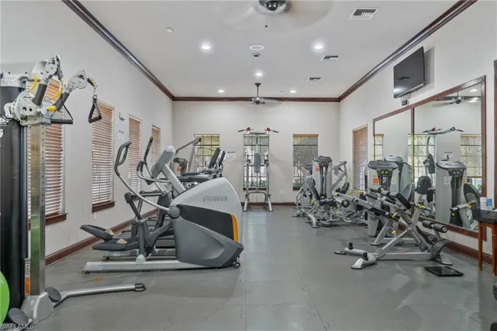 Gym featuring crown molding, recessed lighting, and a ceiling fan