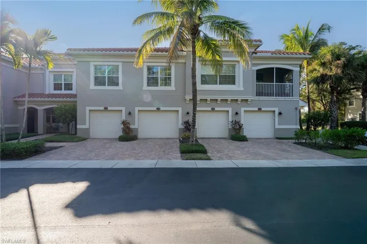 Mediterranean / spanish-style home with a tile roof, an attached garage, stucco siding, and driveway