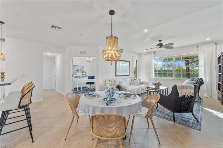 Dining room with hanging lights, a ceiling fan, and light tile patterned floors