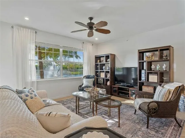 Living area with a ceiling fan and recessed lighting