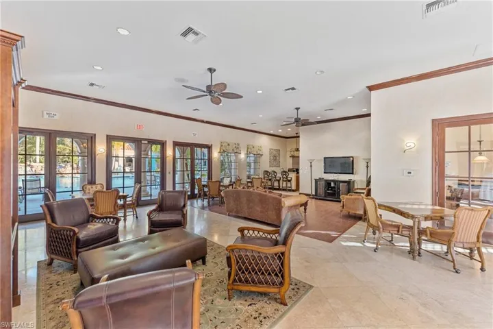 Living area with french doors, healthy amount of natural light, recessed lighting, crown molding, and light tile patterned floors