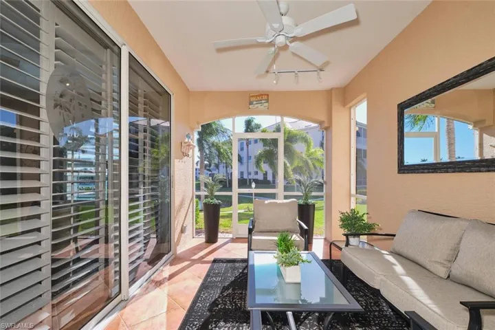 Sunroom with track lighting and tile patterned flooring