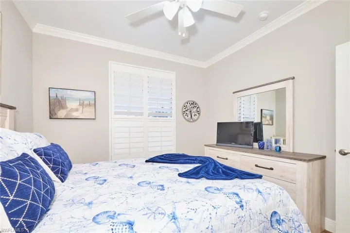 Bedroom featuring ornamental molding and ceiling fan