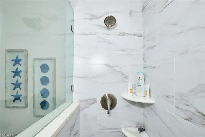 Full bathroom featuring a marble finish shower