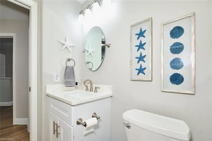 Bathroom with vanity and dark wood-style flooring