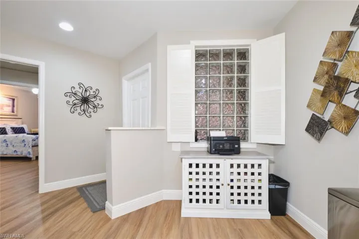 Detailed view of wood finished floors and recessed lighting