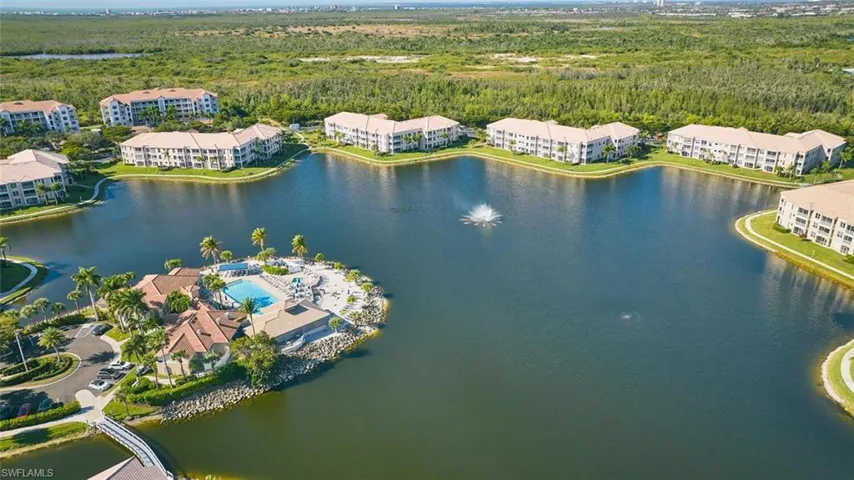 Aerial view of apartment complex and a large body of water