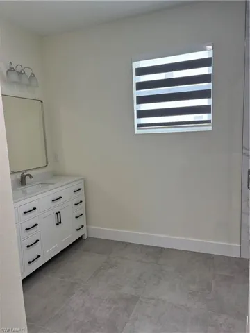 Full bathroom featuring baseboards and vanity