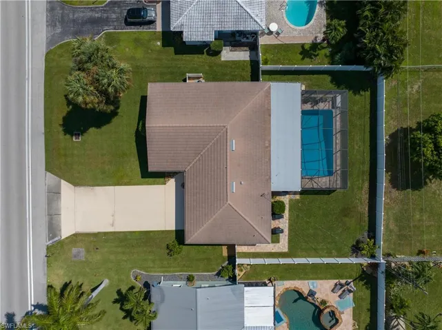 Aerial view showing fenced in pool and backyard area.