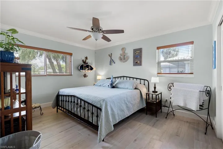 2nd Bedroom with king sized bed and multiple windows.