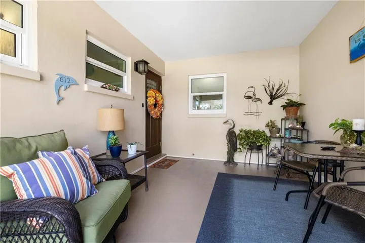 Screened in front sitting area leading to front home entry door.