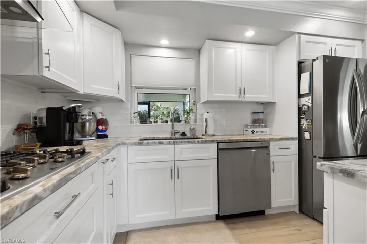 Beautiful and functional Kitchen decorative backsplash brightly lit.