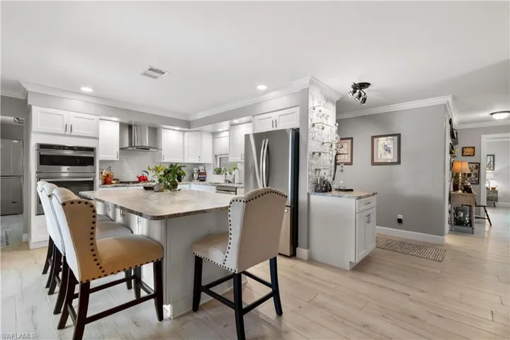 Kitchen large leather texture granite island with storage!   Custom white soft close cabinetry, and stainless steel appliances and gas stovetop.