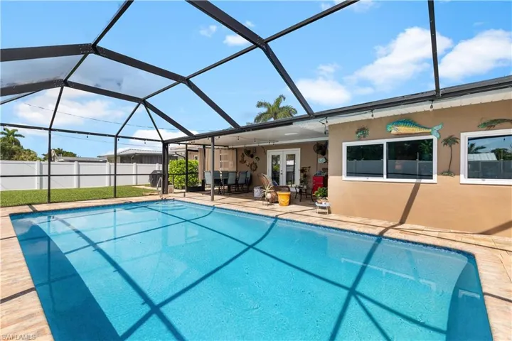 Heated saltwater swimming pool, lanai relaxing and entertaining area with french doors to Kitchen.