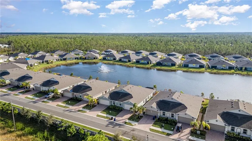 Birds eye view of property with a water view