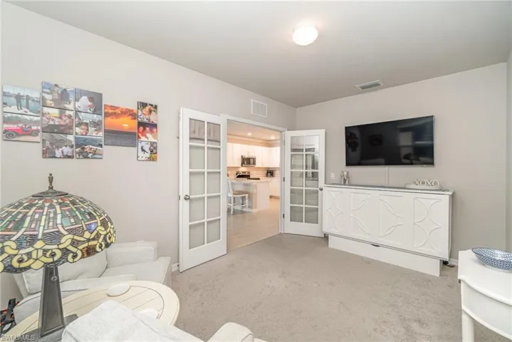 Living room featuring french doors and carpet flooring