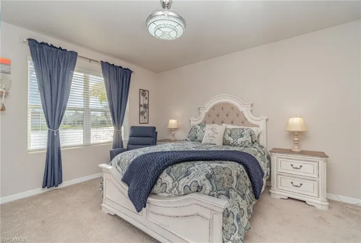 Carpeted bedroom with multiple windows