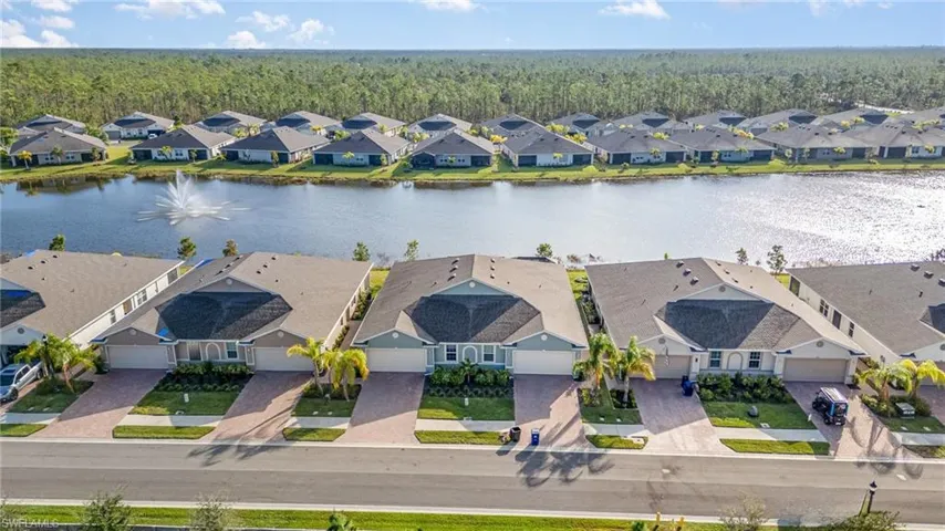 Birds eye view of property with a water view