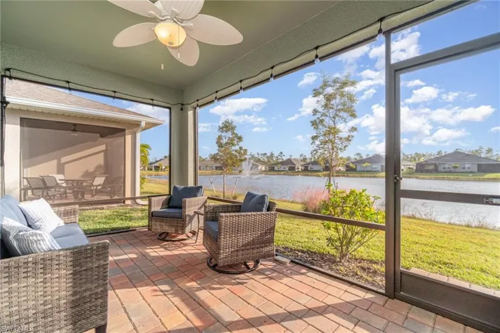 Lanai with a water view and ceiling fan