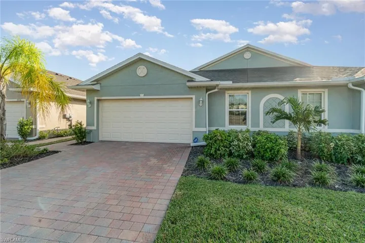 Single story home with a front lawn and a garage