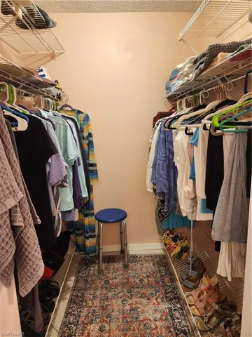 Walk in closet with light tile patterned flooring
