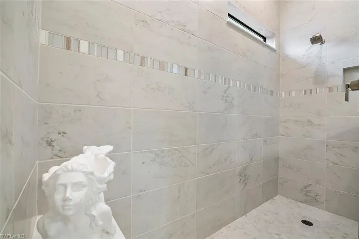 Bathroom featuring a tile shower
