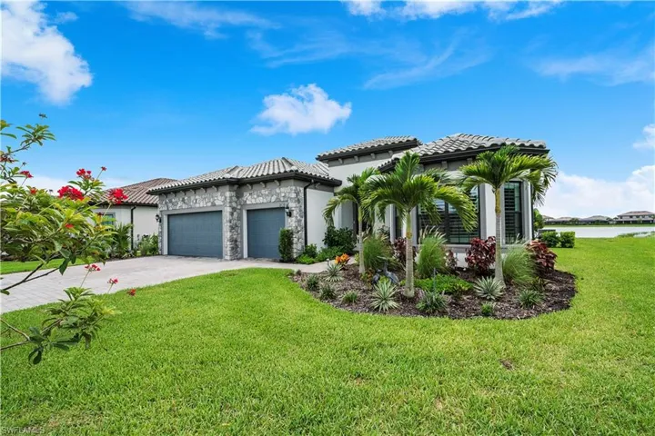 Home featuring a garage and a front yard
