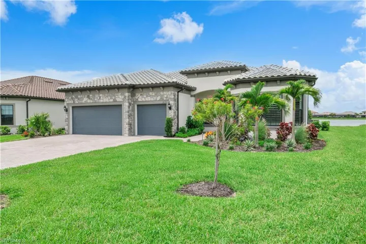 Home with a garage and a front lawn